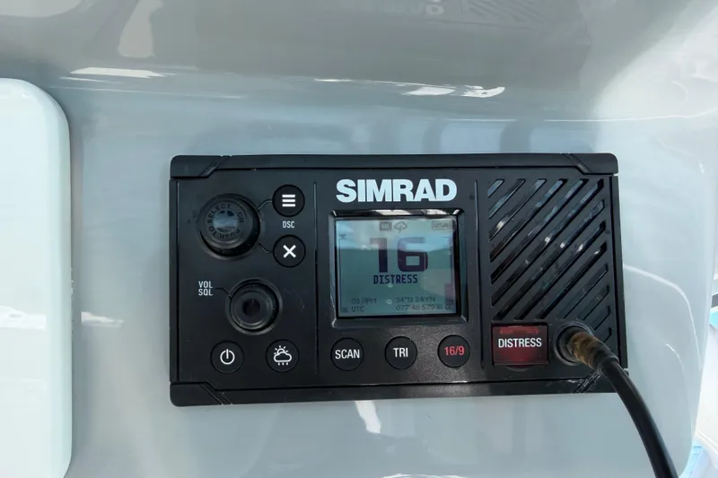 Slide: The Image of Simrad marine radio on 2024 Sea Pro 240 Dual Console, displaying channel 16 distress signal. - 38