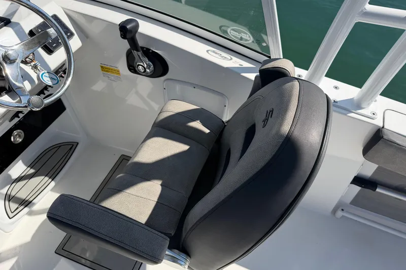 Slide: The Image of 2024 Sea Pro 240 Dual Console helm with steering wheel and comfortable seating. - 41