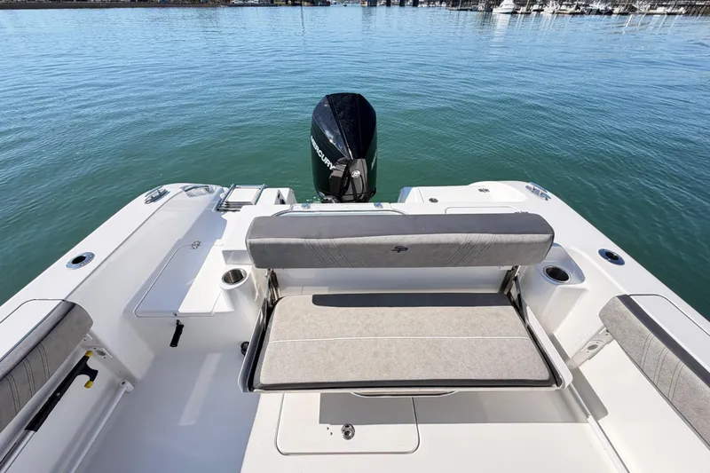 Slide: The Image of 2024 Sea Pro 240 Dual Console boat with seating and outboard motor on calm water. - 48