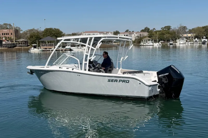 Slide: The Image of 2024 Sea Pro 240 Dual Console boat on calm water, featuring a Mercury outboard engine. - 5