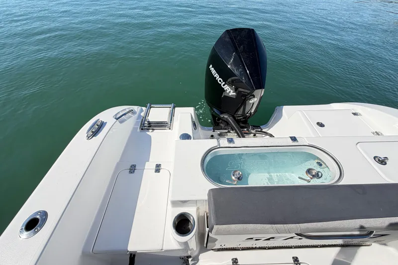 Slide: The Image of 2024 Sea Pro 240 Dual Console boat with Mercury engine on calm water. - 51