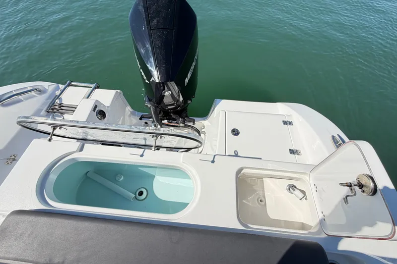 Slide: The Image of 2024 Sea Pro 240 Dual Console boat with outboard motor and fishing amenities. - 52