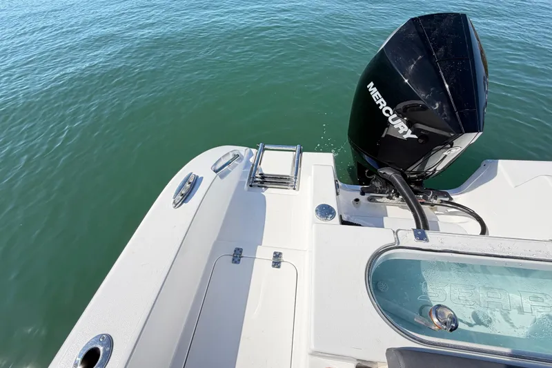 Slide: The Image of 2024 Sea Pro 240 Dual Console boat with Mercury engine on calm water. - 56