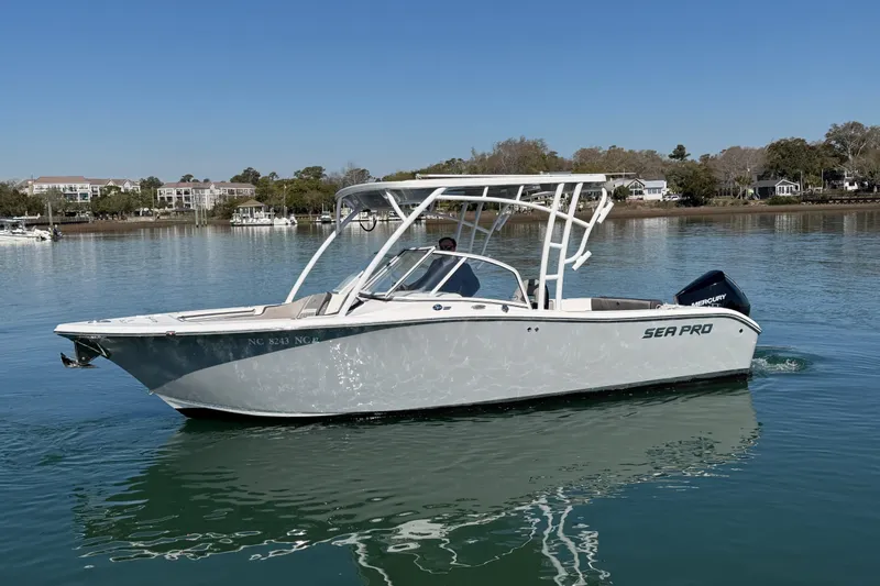 Slide: The Image of 2024 Sea Pro 240 Dual Console boat on calm water, showcasing sleek design and modern features. - 9