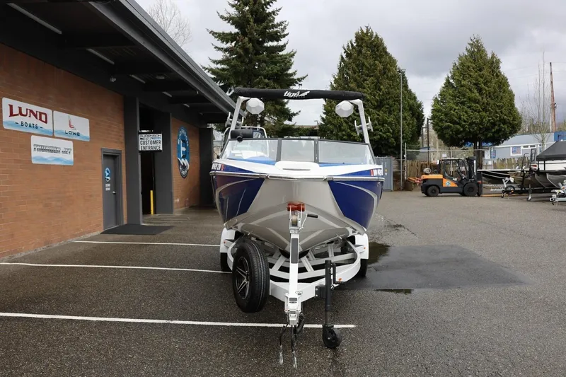 Slide: The Image of 2023 Tigé Z3 boat parked outside dealership, showcasing sleek design and modern features. - 12