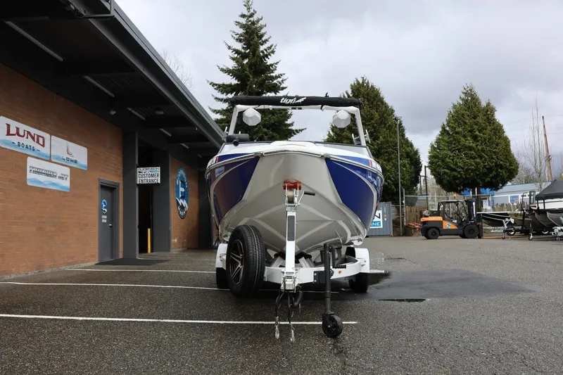Slide: The Image of 2023 Tigé Z3 boat on trailer outside dealership, overcast day. - 13
