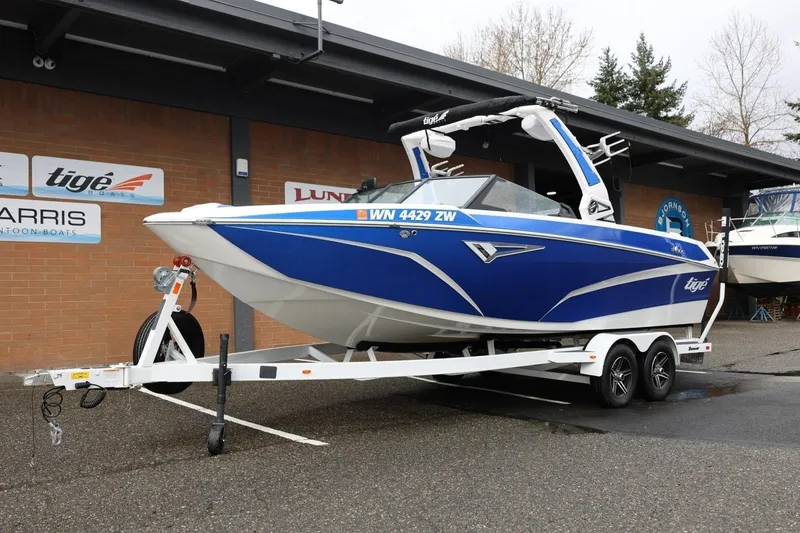 Slide: The Image of 2023 Tigé Z3 boat in blue on a trailer outside a dealership. - 15