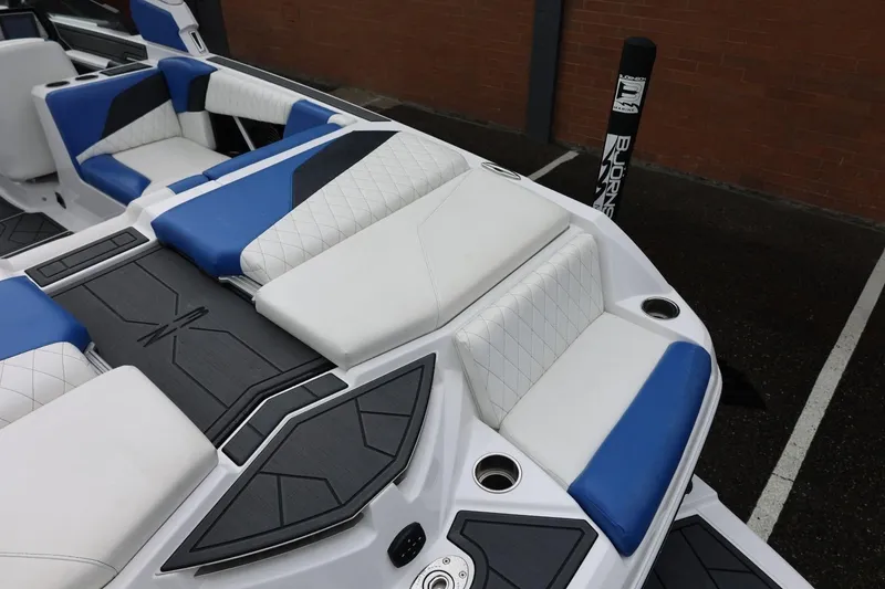 Slide: The Image of 2023 Tigé Z3 boat interior with blue and white seating, modern design. - 16