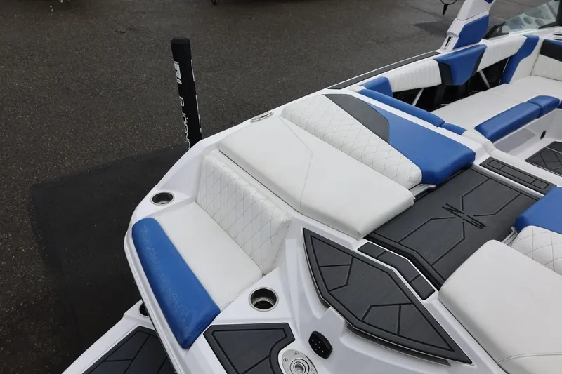 Slide: The Image of 2023 Tigé Z3 boat interior with blue and white seating, showcasing modern design. - 17