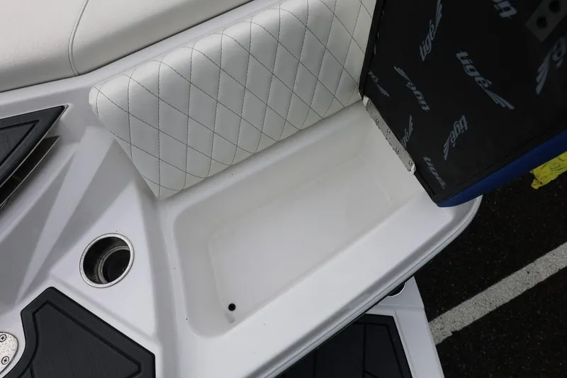 Slide: The Image of 2023 Tigé Z3 boat interior with white diamond-stitched seating and storage compartment. - 19