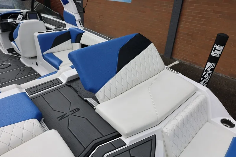 Slide: The Image of 2023 Tigé Z3 boat interior with blue and white seating and modern design. - 23