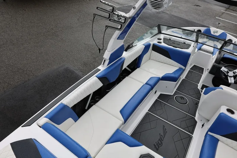 Slide: The Image of 2023 Tigé Z3 boat interior with blue and white seating, modern design. - 24