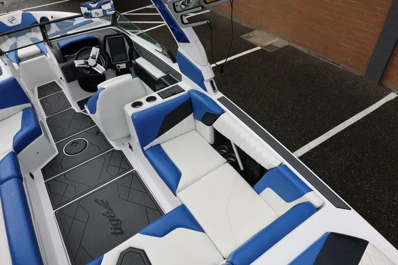 Slide: The Image of 2023 Tigé Z3 boat interior with blue and white seating, modern dashboard, and sleek design. - 25