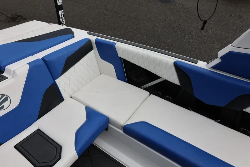 Slide: The Image of 2023 Tigé Z3 boat interior with blue and white cushioned seating. - 29
