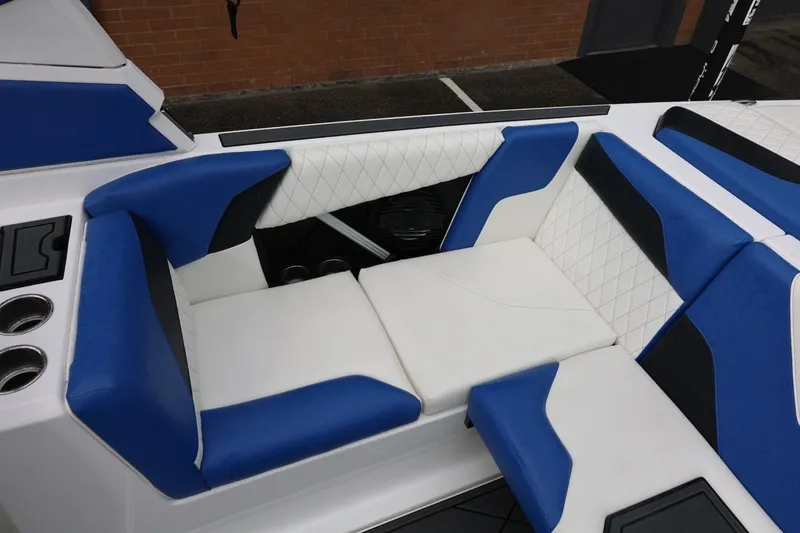 Slide: The Image of 2023 Tigé Z3 boat interior with blue and white seating, featuring quilted upholstery. - 31