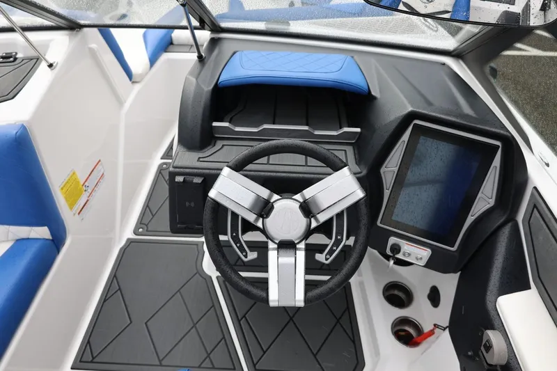 Slide: The Image of 2023 Tigé Z3 boat cockpit with modern steering wheel and touchscreen display. - 33