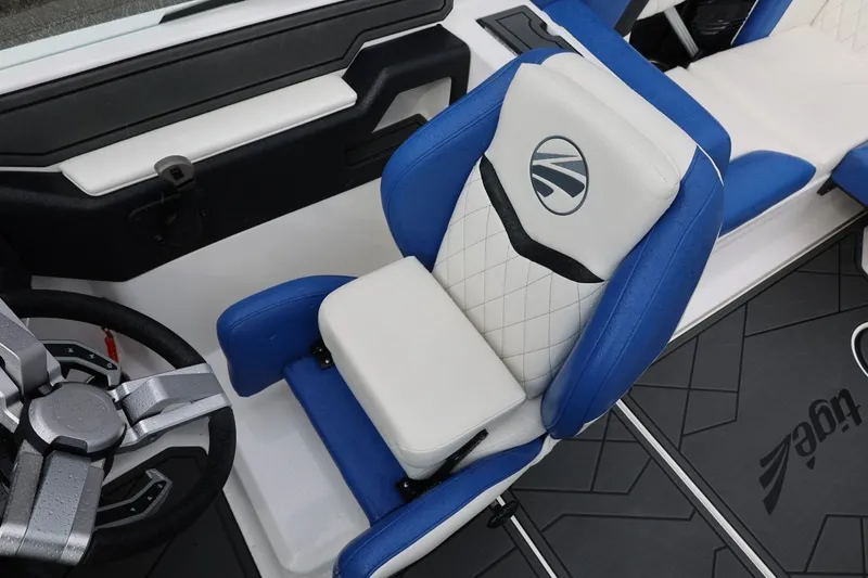 Slide: The Image of 2023 Tigé Z3 boat interior with blue and white seating and modern steering wheel. - 35