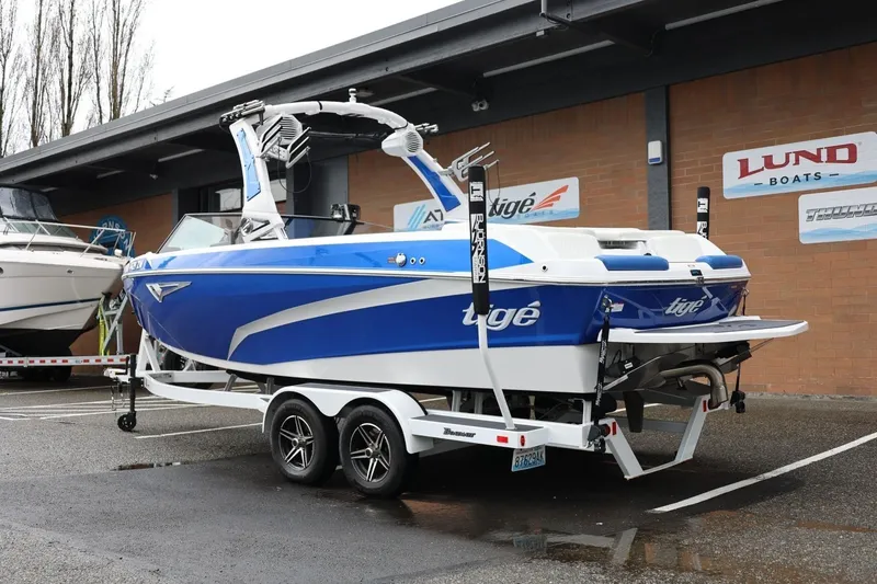 Slide: The Image of 2023 Tigé Z3 boat in blue and white on a trailer outside a dealership. - 4
