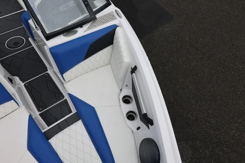 Slide: The Image of 2023 Tigé Z3 boat interior with blue and white seating, cup holders, and sleek design. - 43