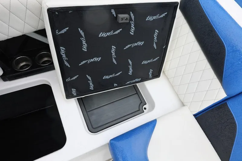 Slide: The Image of 2023 Tigé Z3 boat interior with open storage compartment and blue-white seating. - 46