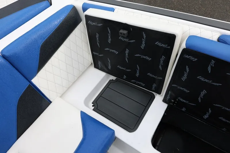 Slide: The Image of 2023 Tigé Z3 boat interior with blue and white seating and storage compartments. - 48