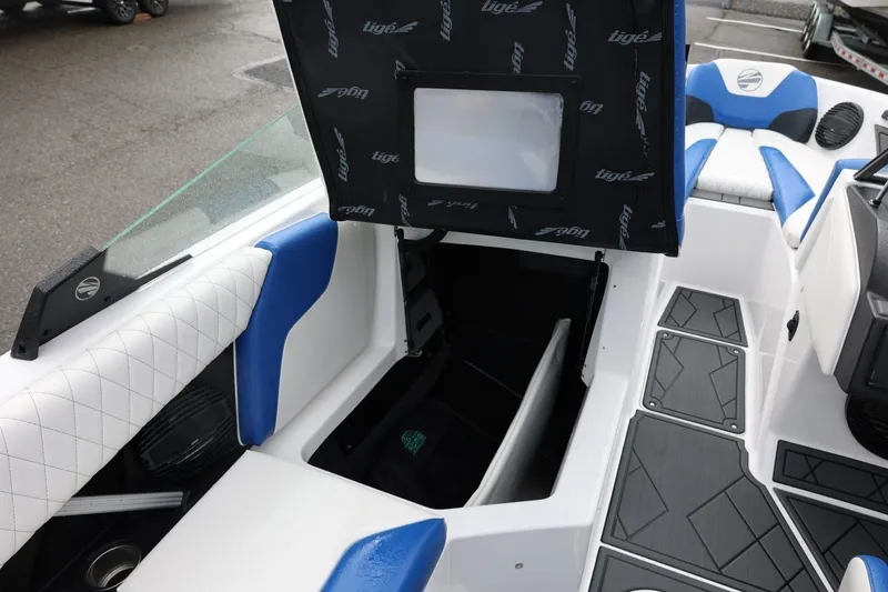 Slide: The Image of 2023 Tigé Z3 boat interior with open storage compartment and blue-white seating. - 50