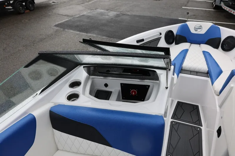 Slide: The Image of 2023 Tigé Z3 boat interior with blue and white seating, windshield, and cup holders. - 51