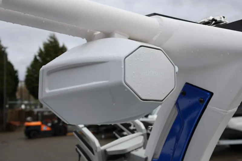 Slide: The Image of Close-up of a 2023 Tigé Z3 boat speaker system in a marina setting. - 52