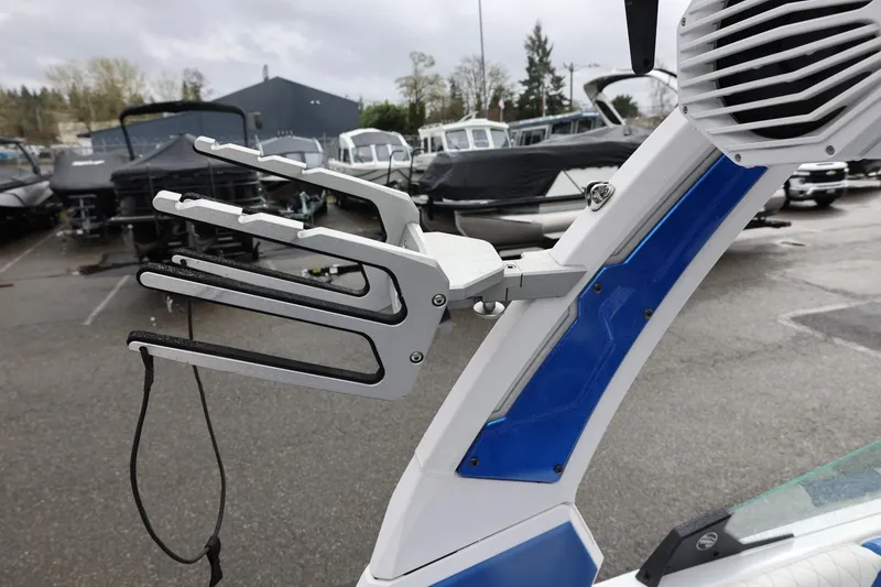 Slide: The Image of 2023 Tigé Z3 boat with wakeboard rack and speaker in a marina setting. - 55