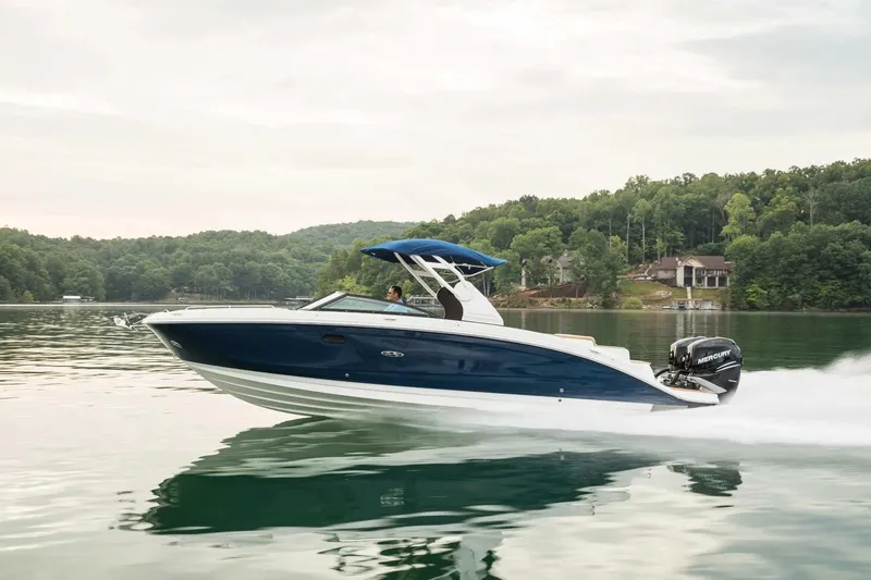 The Image of 2017 Sea Ray SDX 290 Outboard cruising on a serene lake with lush green surroundings. - 0