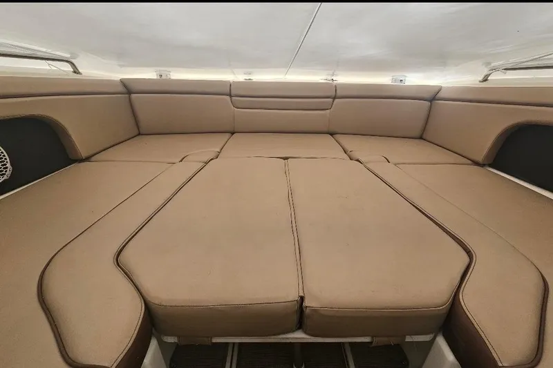 Slide: The Image of 2017 Sea Ray SDX 290 Outboard interior with spacious tan seating area. - 14