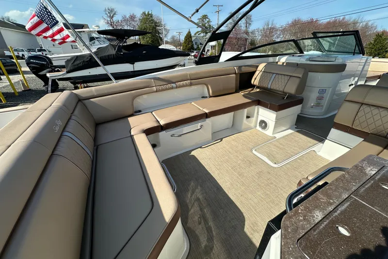 Slide: The Image of 2017 Sea Ray SDX 290 Outboard boat interior with luxurious seating and American flag. - 18