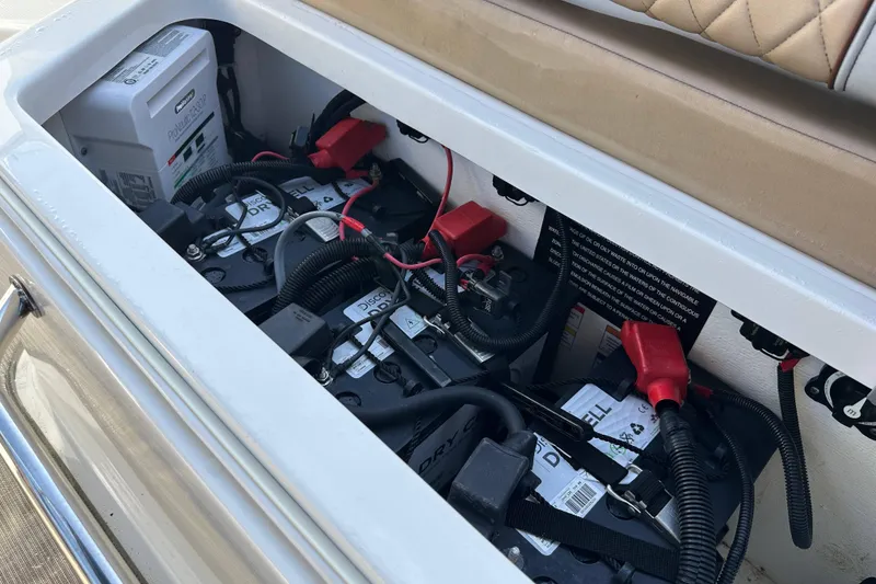Slide: The Image of Battery compartment of a 2017 Sea Ray SDX 290 Outboard boat, showing multiple batteries and wiring. - 20