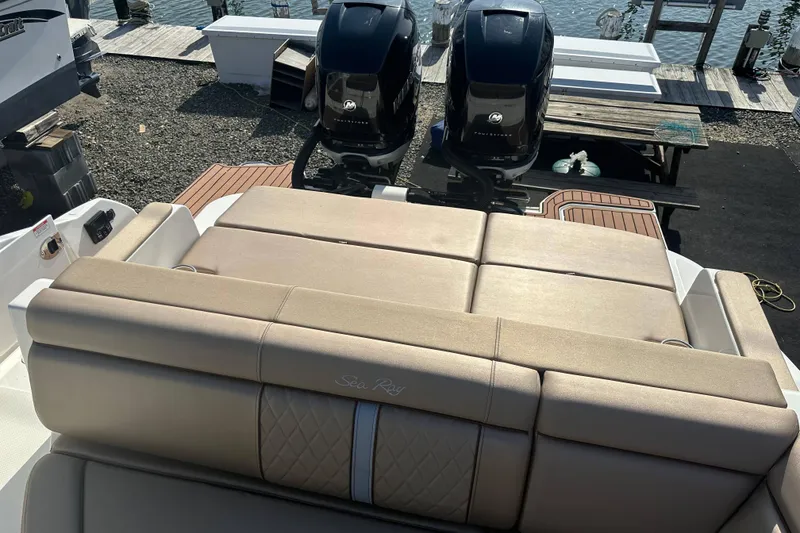Slide: The Image of 2017 Sea Ray SDX 290 Outboard boat with dual engines and luxurious seating at a dock. - 24