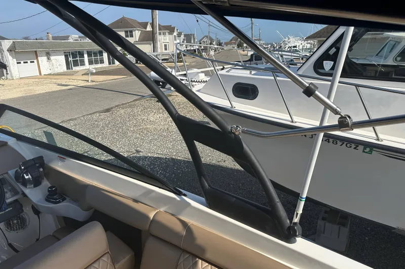 Slide: The Image of 2017 Sea Ray SDX 290 Outboard interior with view of marina and neighboring boats. - 25