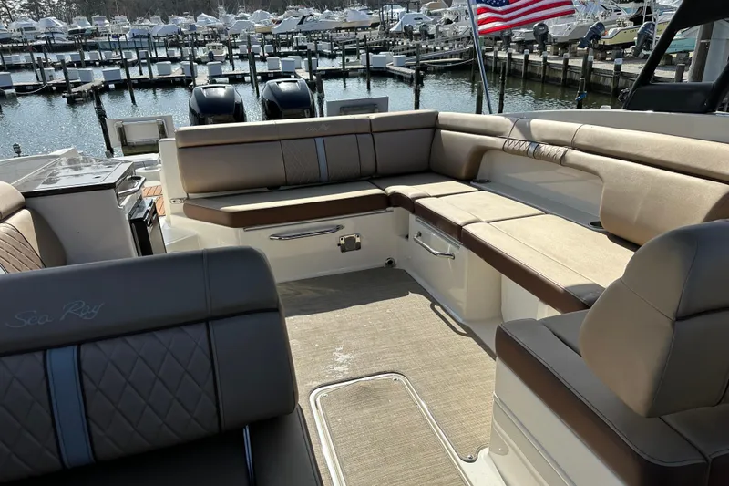 Slide: The Image of 2017 Sea Ray SDX 290 Outboard boat interior with spacious seating, docked at marina. - 27