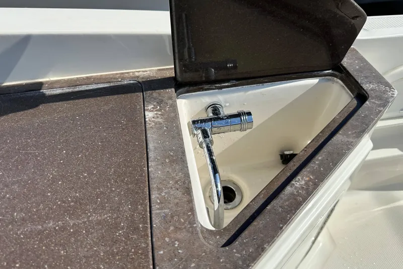 Slide: The Image of 2017 Sea Ray SDX 290 Outboard boat sink with chrome faucet and countertop. - 29