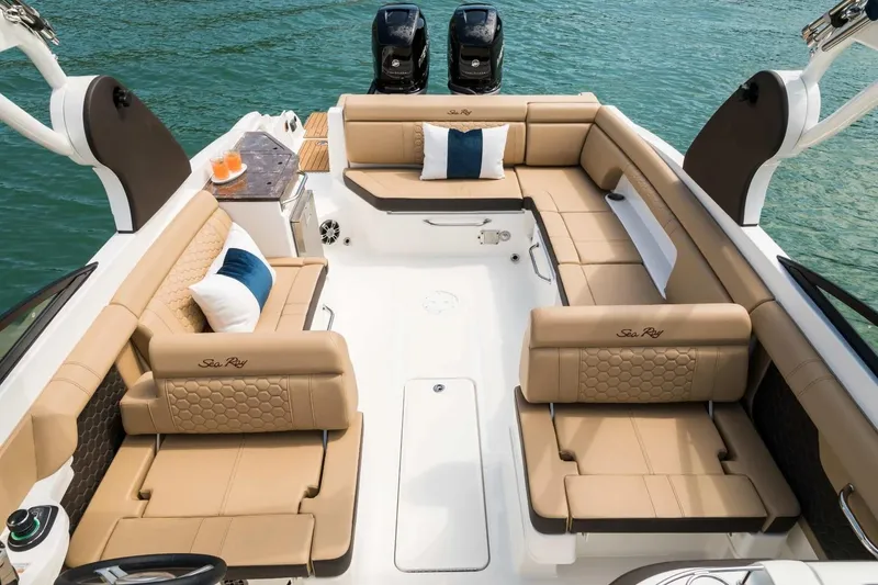 Slide: The Image of Luxurious 2017 Sea Ray SDX 290 Outboard boat interior with tan seating and cushions. - 5