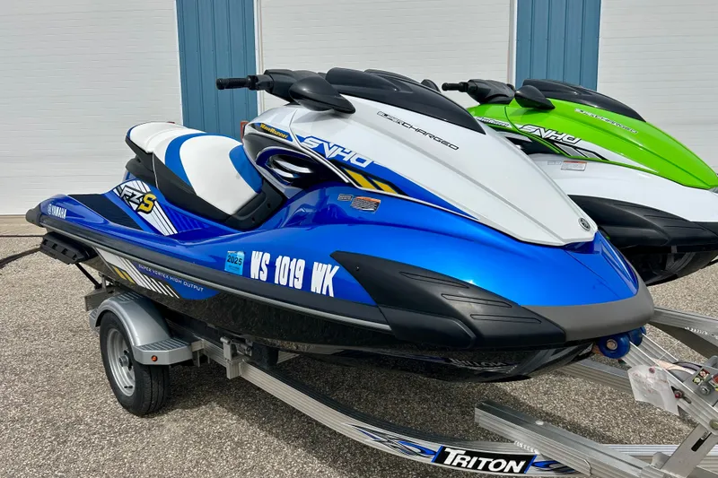 Slide: The Image of 2016 Yamaha WaveRunner FZS in blue on a trailer, parked outdoors. - 2