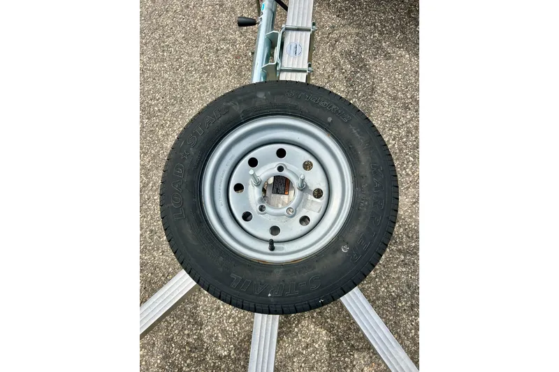 Slide: The Image of Trailer tire on a Yamaha WaveRunner FZS, 2016 model, on asphalt surface. - 39