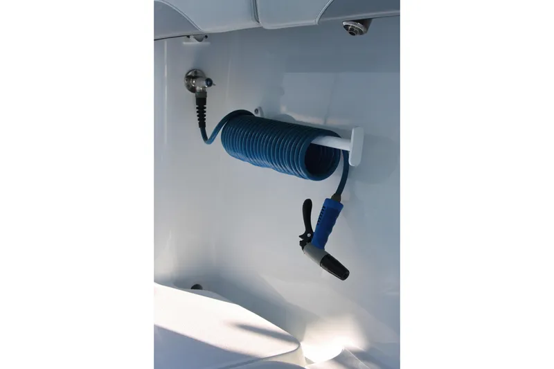 Slide: The Image of Blue coiled hose on 2025 Yellowfin 36 Offshore boat, neatly mounted on white wall. - 11
