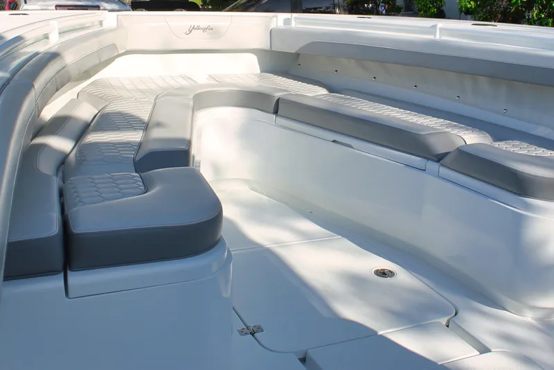 Slide: The Image of 2025 Yellowfin 36 Offshore boat interior with cushioned seating and sleek design. - 13