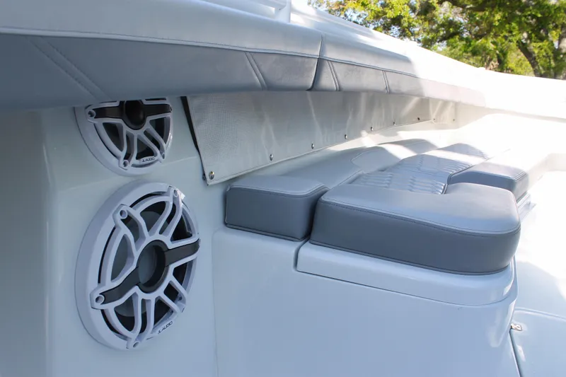Slide: The Image of 2025 Yellowfin 36 Offshore boat interior with cushioned seating and built-in speakers. - 14