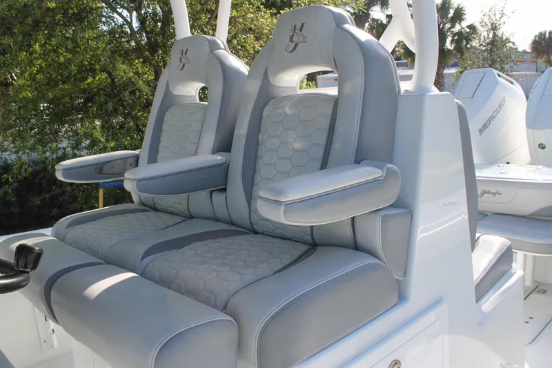 Slide: The Image of 2025 Yellowfin 36 Offshore boat seats with gray upholstery and armrests. - 18