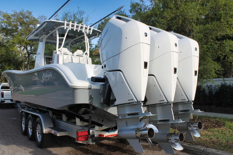 Slide: The Image of 2025 Yellowfin 36 Offshore boat with triple outboard engines on a trailer. - 2