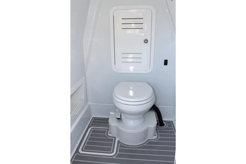 Slide: The Image of 2025 Yellowfin 36 Offshore boat bathroom with modern toilet and storage compartment. - 22