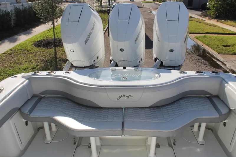 Slide: The Image of 2025 Yellowfin 36 Offshore boat with triple Mercury engines and cushioned seating. - 23