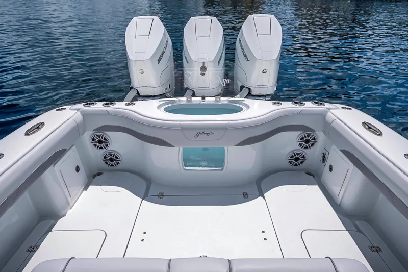 Slide: The Image of 2025 Yellowfin 36 Offshore boat with triple Mercury engines on calm water. - 26