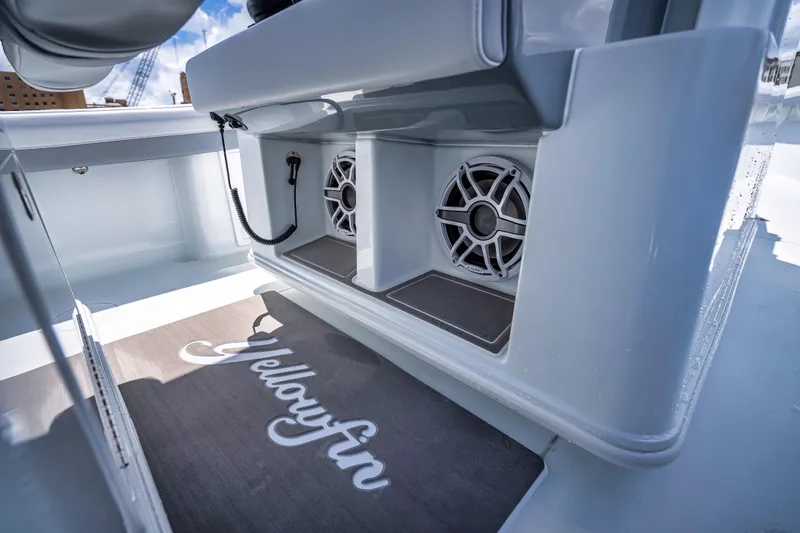 Slide: The Image of 2025 Yellowfin 36 Offshore boat interior with speakers and branded mat. - 31