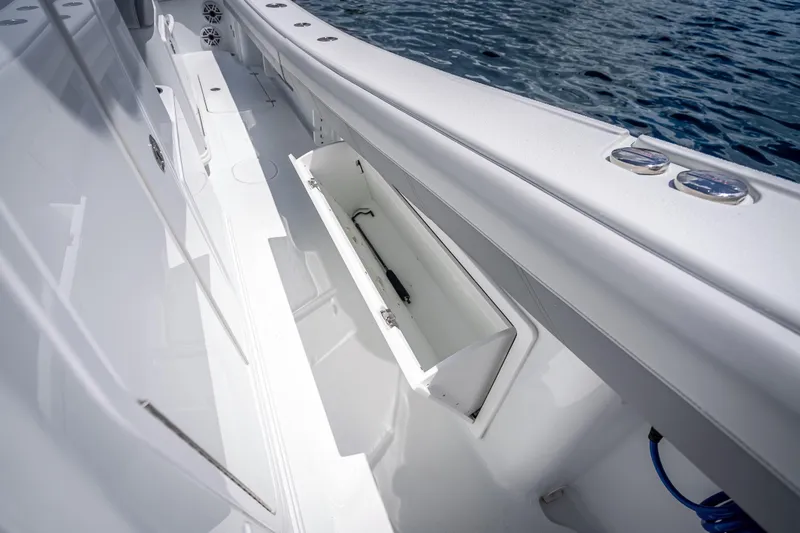 Slide: The Image of 2025 Yellowfin 36 Offshore boat deck with open storage compartment. - 33
